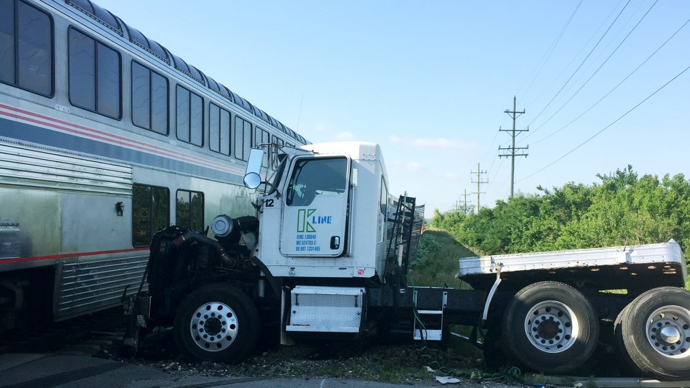 A train is stopped following a train collision near Wilmington, Ill., June 5, 2015. The Amtrak train was headed to Chicago from San Antonio and slammed into a semitrailer at a crossing. (Photo by Sam Herwitz/AP)