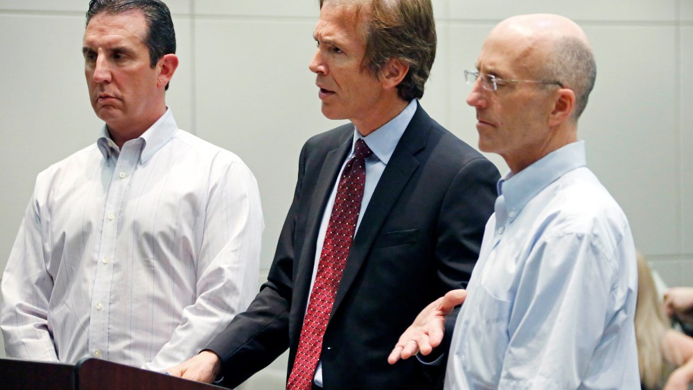 Mark Mayfield, a member of the board of the Central Mississippi Tea Party, right, listens as his attorney Merrida Coxwell, center, responds to questions, May 22, 2014, during an initial court appearance.