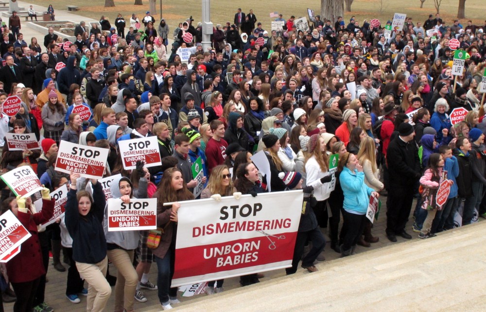 Hundreds of abortion opponents rally at the Kansas Statehouse, Jan. 22, 2015, in Topeka. The rally was sponsored by Kansans for Life on the 42nd anniversary of the U.S. Supreme Court decision legalizing abortion across the nation. (Photo by John Hanna/AP)