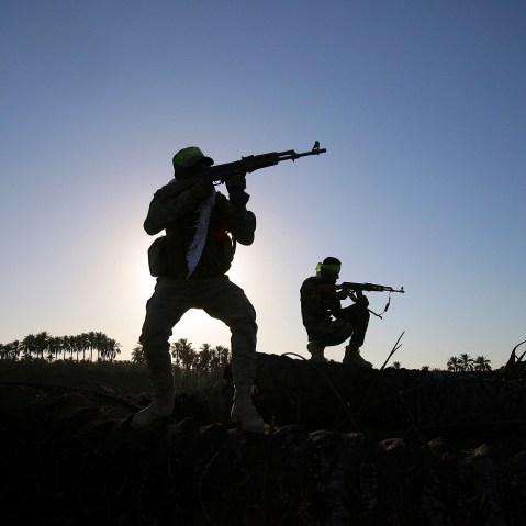 In this, Oct . 7, 2014 file photo, Iraqi Shiite militiamen aim their weapons during clashes with militants from the Islamic State group, in Jurf al-Sakhar, about 43 miles southwest of Baghdad, Iraq. (Photo by AP)