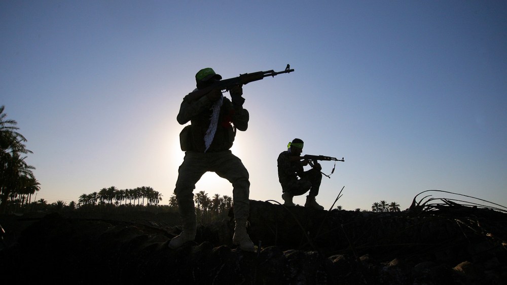 In this, Oct . 7, 2014 file photo, Iraqi Shiite militiamen aim their weapons during clashes with militants from the Islamic State group, in Jurf al-Sakhar, about 43 miles southwest of Baghdad, Iraq. (Photo by AP)