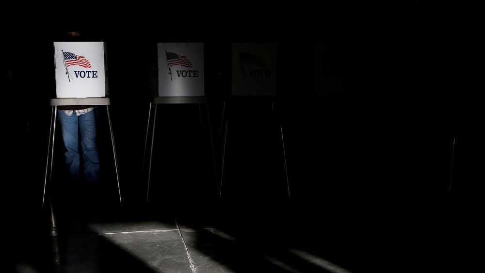 Voting booths are illuminated by sunlight as voters cast their ballots at a polling place in Billings, Mont., Nov. 6, 2012.