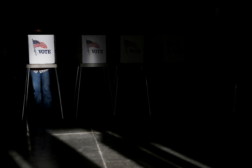 Voting booths are illuminated by sunlight as voters cast their ballots at a polling place in Billings, Mont., Nov. 6, 2012.
