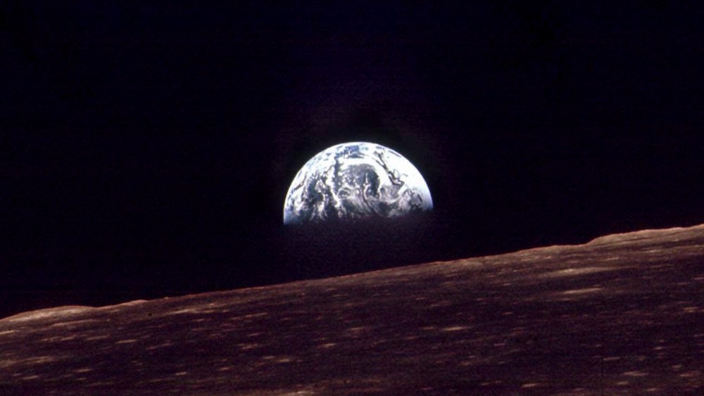 n this Dec. 24, 1968 file photo, the Earth shines over the horizon of the Moon in as seen by the astronauts on Apollo 8.