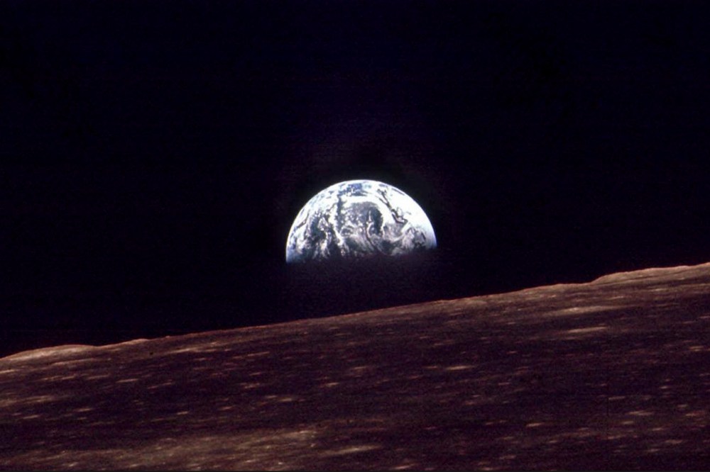n this Dec. 24, 1968 file photo, the Earth shines over the horizon of the Moon in as seen by the astronauts on Apollo 8.