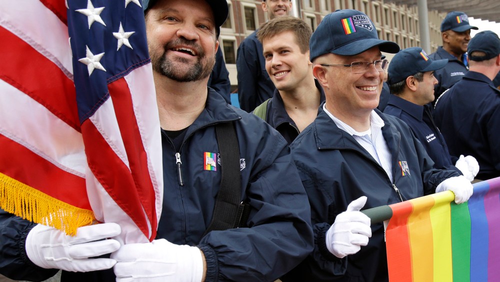 Retired U.S. Air Force Master Sgt. Eric Bullen, of Westborough, Mass., left, and U.S. Army veteran Ian Ryan, of Dennis, Mass.are seen after marching with a group representing LGBT military veterans in a Veterans Day parade, Nov. 11, 2014, in Boston, Mass.