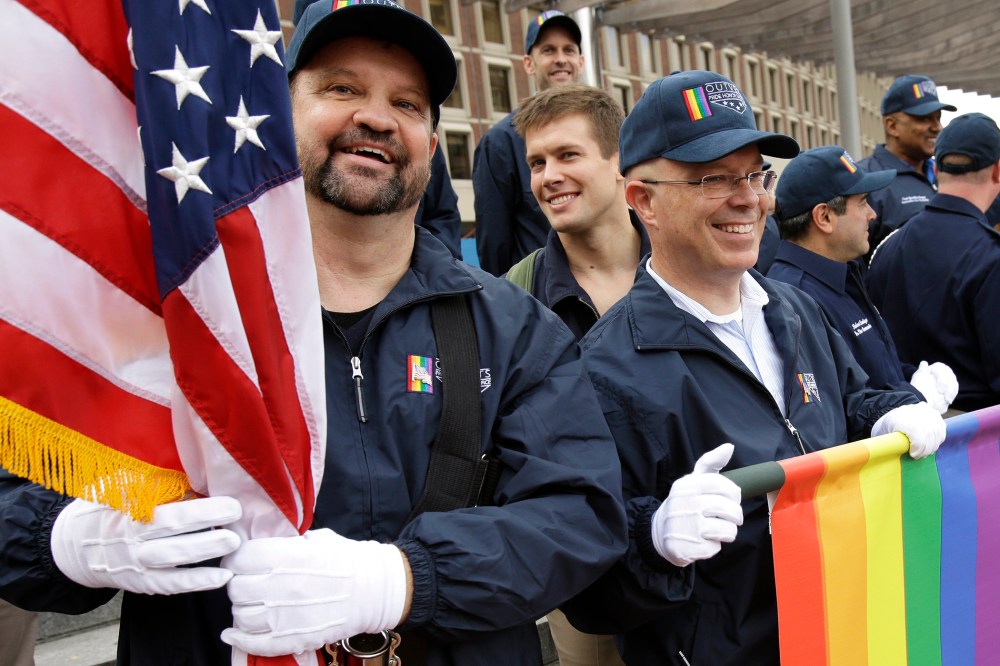 Retired U.S. Air Force Master Sgt. Eric Bullen, of Westborough, Mass., left, and U.S. Army veteran Ian Ryan, of Dennis, Mass.are seen after marching with a group representing LGBT military veterans in a Veterans Day parade, Nov. 11, 2014, in Boston, Mass.