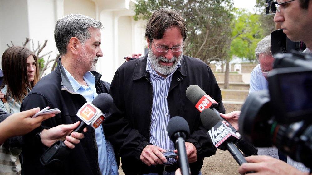 Richard Martinez is comforted by his brother, Alan, as he talks to media outside the Santa Barbara County Sheriff's Headquarters, May 24, 2014.