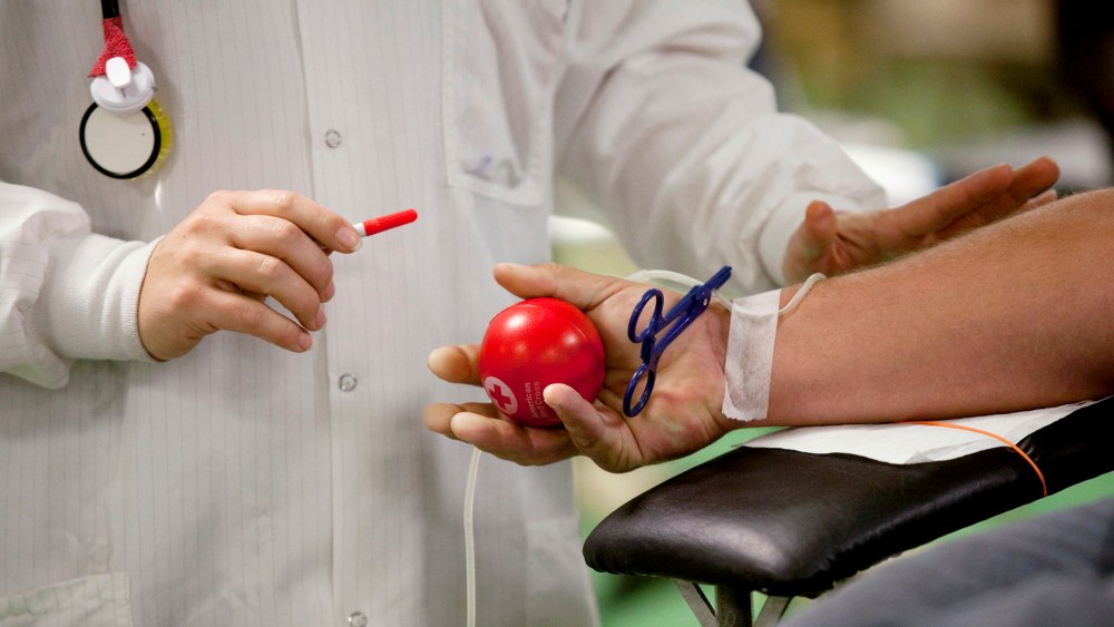 In this Nov. 1, 2014 photo, Kimilee Day, a team leader with the American Red Cross, prepares a patient to give blood during a blood drive at First United Methodist Church in Decatur, Ill. (Photo by Danny Damiani/Herald & Review/AP)