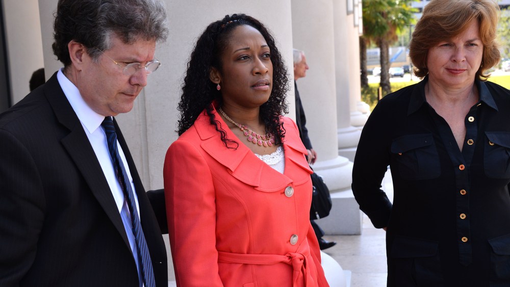 Defense co-counsel Bruce Zimet, left, and Faith Gay, right, stand with Marissa Alexander as they speak to the media, June 10, 2014 in Jacksonville, Fla.