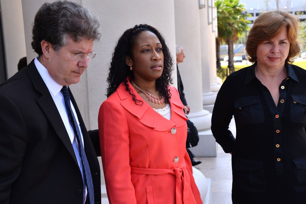 Defense co-counsel Bruce Zimet, left, and Faith Gay, right, stand with Marissa Alexander as they speak to the media, June 10, 2014 in Jacksonville, Fla.