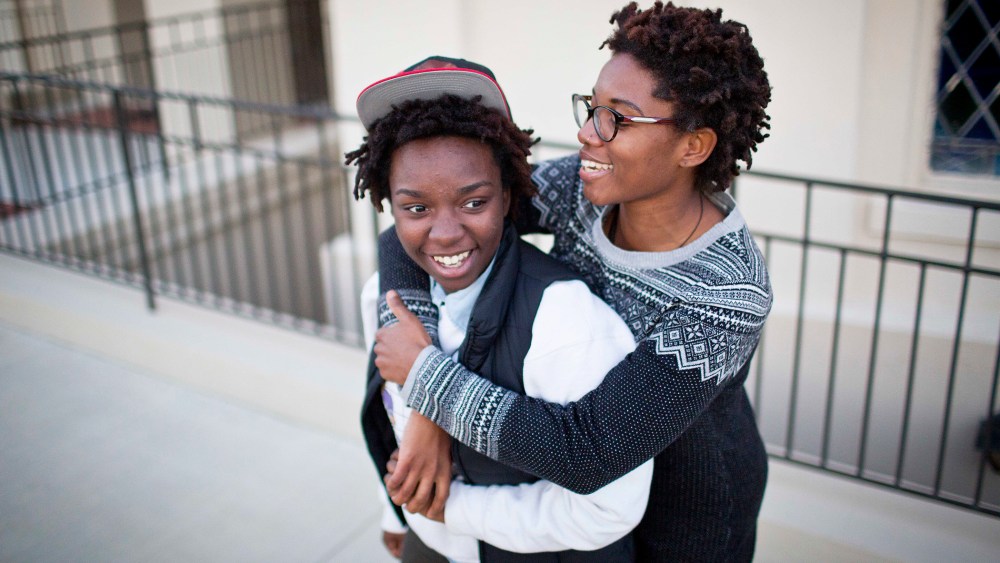 Shanté Wolfe, left and Tori Sisson embrace near the Montgomery County Courthouse, Jan. 25, 2015, in Montgomery, Ala., where they plan to stay overnight to be married Monday morning. (Photo by Brynn Anderson/AP)