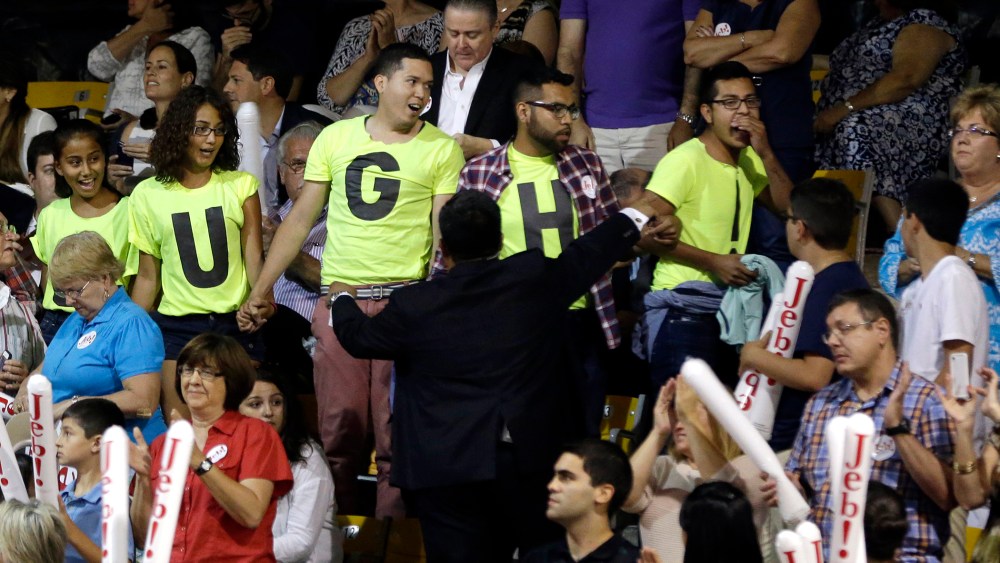 Immigration reform protestors are led outside after they interrupted a speech by former Florida Gov. Jeb Bush as he announces his bid for the Republican presidential nomination, at Miami Dade College, June 15, 2015, in Miami. (Photo by Lynne Sladky/AP)