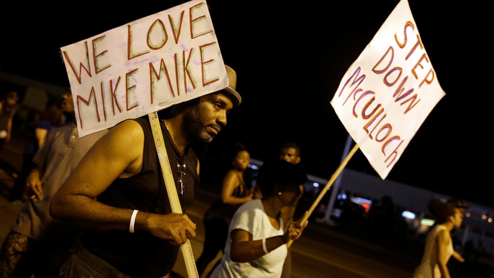 Protesters march Thursday, Aug. 21, 2014, in Ferguson, Mo.