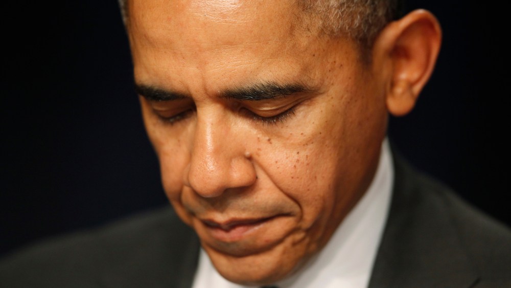 President Barack Obama closes his eyes as a prayer is offered at the National Prayer Breakfast in Washington, Feb. 6, 2014.