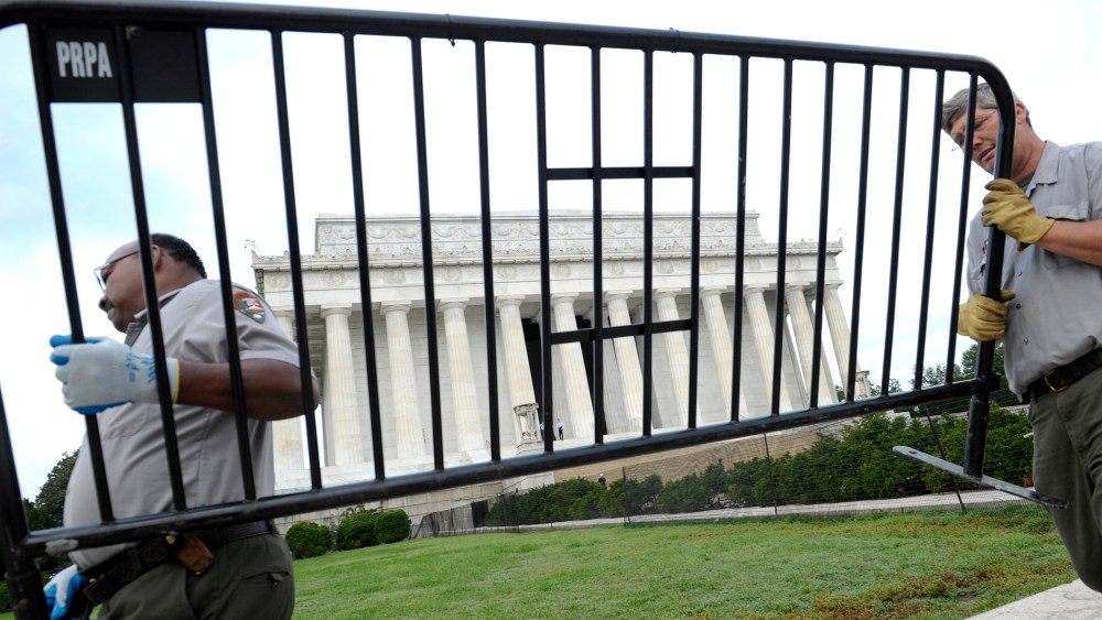 National Park Service employees remove barricades from the grounds of the Lincoln Memorial