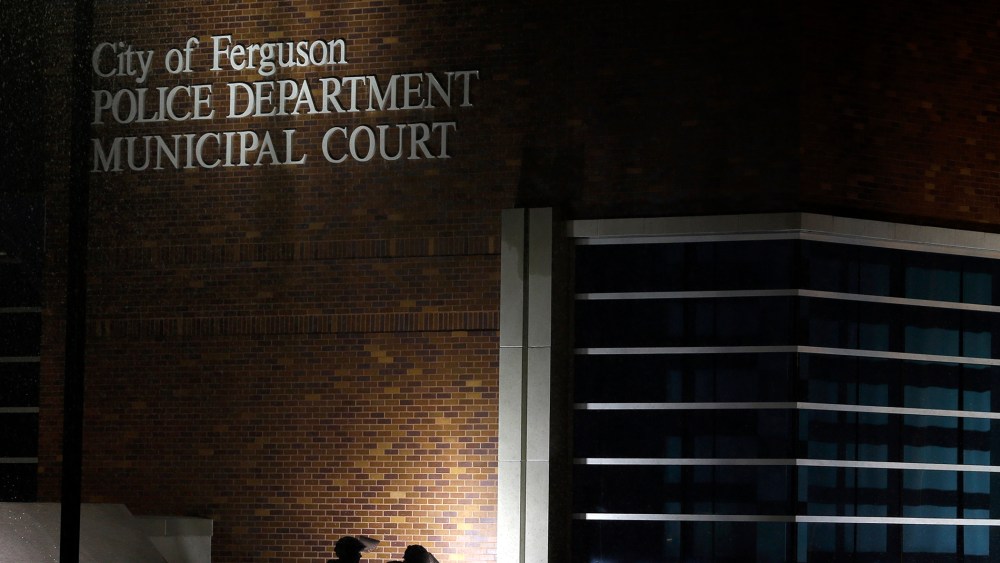 Members of Missouri National Guard stand outside of the Ferguson Police Department and the Municipal Court in Ferguson, Mo. on Nov. 26, 2014. (Photo by Jeff Roberson/AP)