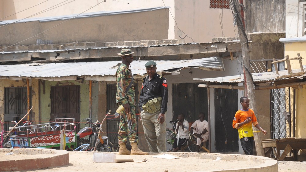 Security forces stand guard at the site of bomb explosion at a market in Maiduguri, Nigeria on March 7, 2015. (Photo by Jossy Ola/AP)