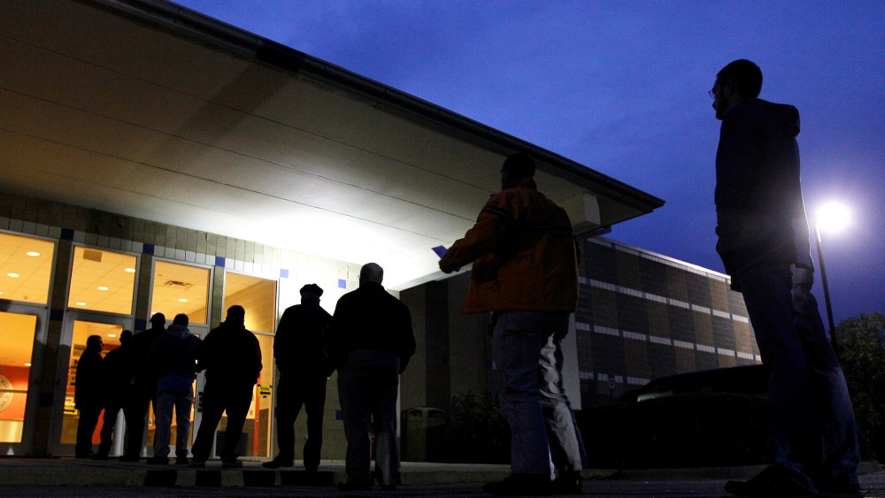 Voters stand in line before the sun rises to cast their votes at a polling precinct at the Wake County Firearms Education and Training Center in Apex, N.C., on Election Day, Nov. 6, 2012.