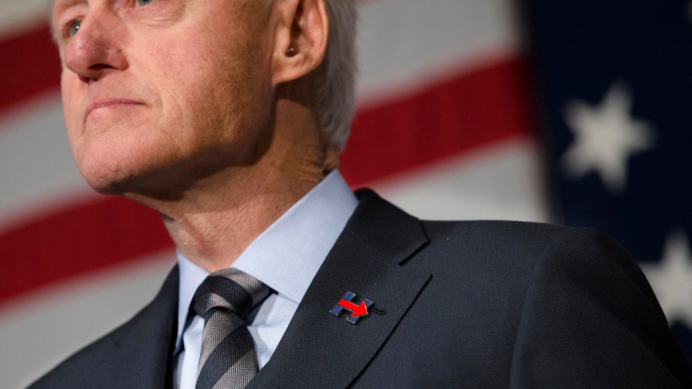 Former President Bill Clinton wears a campaign pin for his wife, Democratic presidential candidate Hillary Clinton, as he campaign for her, Feb. 12, 2016, at the Clifton Cultural Arts Center in Cincinnati. (Photo by John Minchillo/AP)