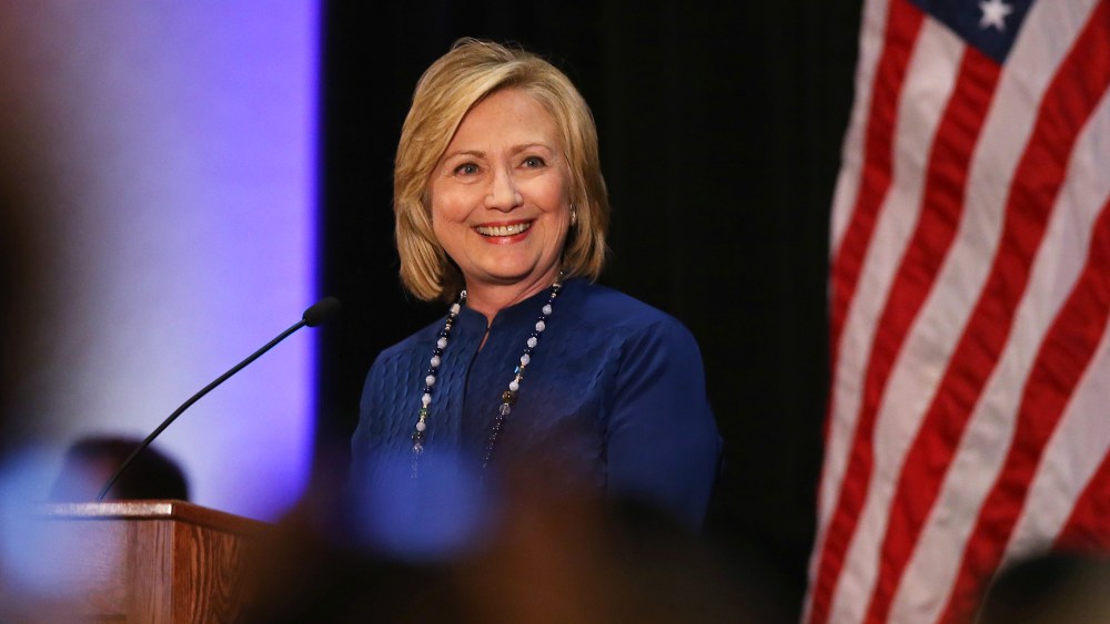 Former Secretary of State Hillary Rodham Clinton acknowledges applause during a speech at an event in the east Denver suburb of Aurora, Colo., on Oct. 21, 2014. (Photo by David Zalubowski/AP)