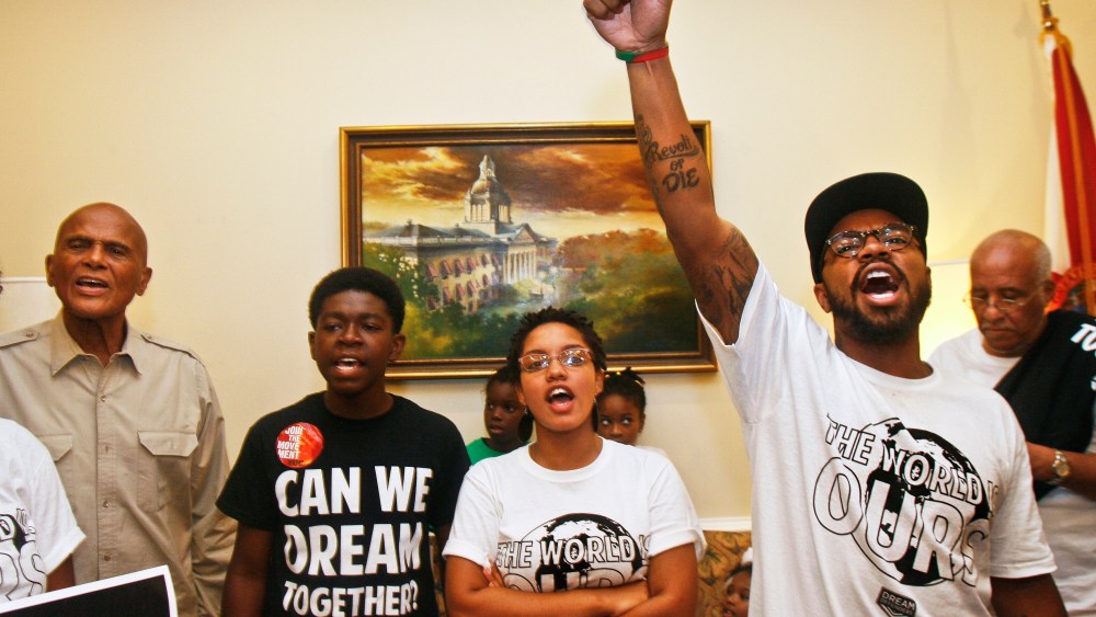 Dream Defenders Executive Director Phillip Agnew raises his fist as he leads a chant calling for a special session Friday, July 26, 2013 in the Capitol in Tallahassee, Florida.