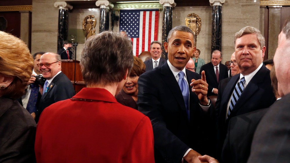 Barack Obama shakes hands after giving the State of Union address, Jan. 28, 2014.
