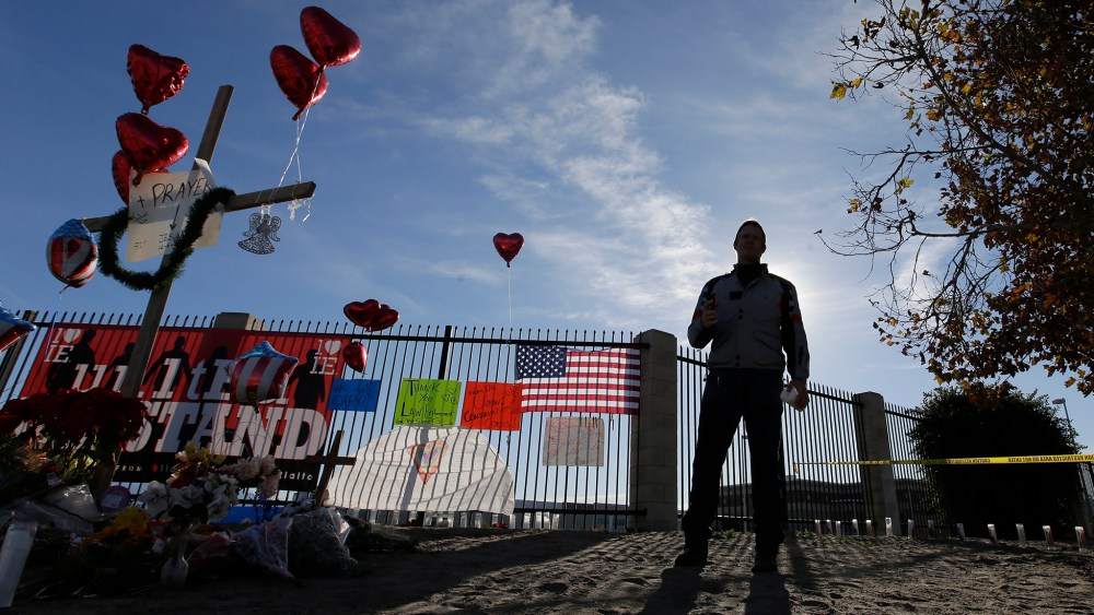 A man pays his respects at a makeshift memorial, Dec. 5, 2015, in San Bernardino, Calif. (Photo by Chris Carlson/AP)