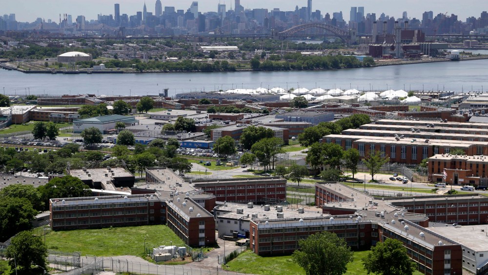 This June 20, 2014 file photo shows the Rikers Island jail with the New York skyline in the background. (Photo by Seth Wenig/AP)