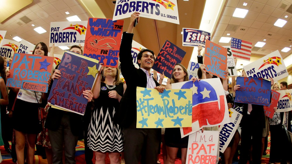 Supporters cheer for U.S. Sen. Pat Roberts at a Johnson County Republican's election watch party, Aug. 5, 2014, in Overland Park, Kan. (Photo by Charlie Riedel/AP)