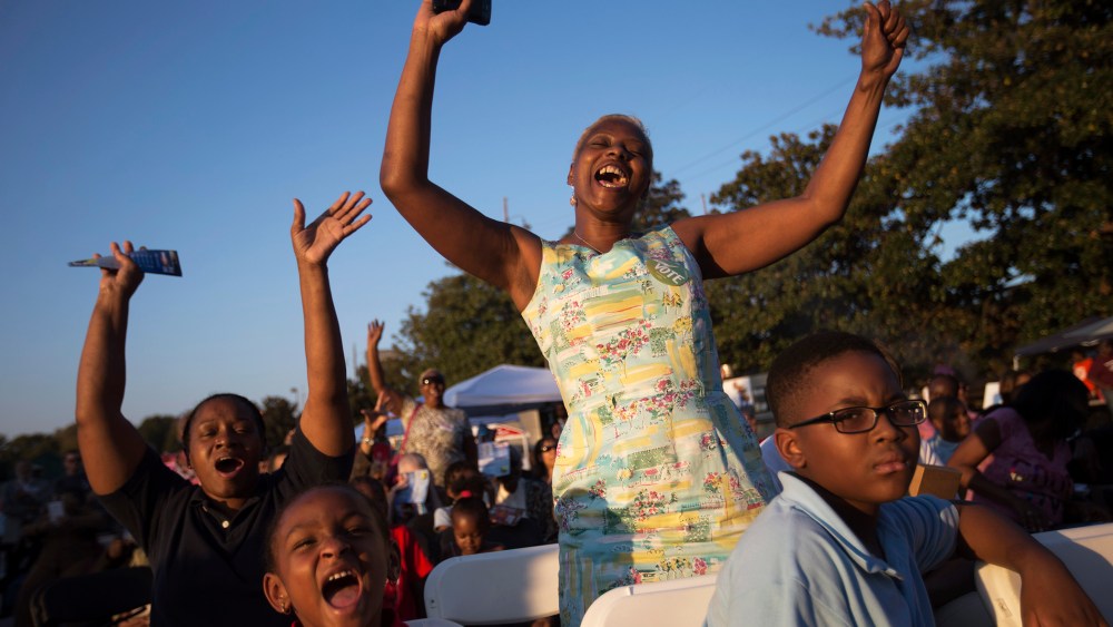 Priscilla Smith, left, and Sabrina Mobley, both of Decatur, Ga., dance before U.S. Senate candidate Michelle Nunn takes the stage, on Oct. 27, 2014, during a Democratic rally encouraging early voting in Decatur, Ga.