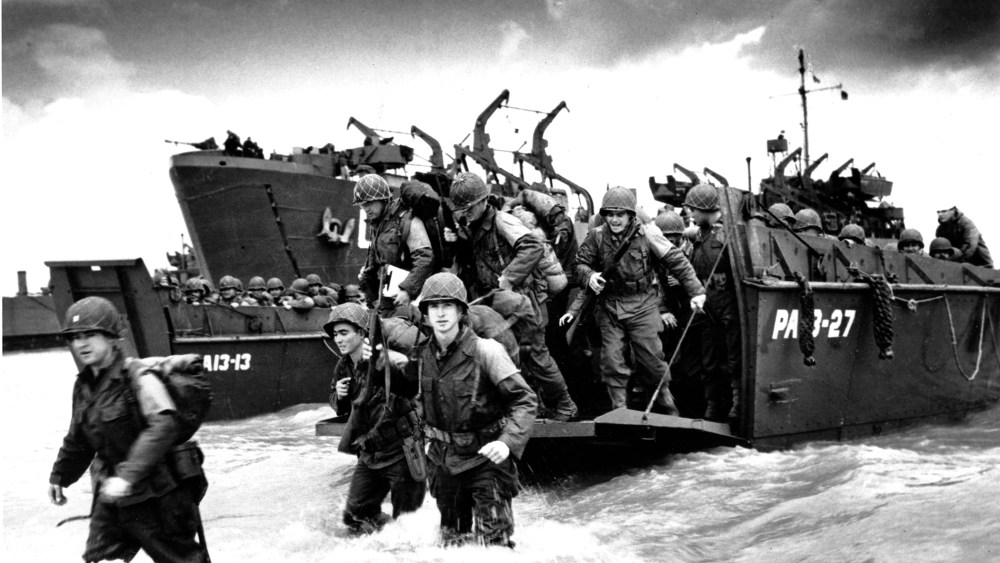 American reinforcements arrive on the beaches of Normandy from a Coast Guard landing barge into the surf on the French coast on June 23, 1944 during World War II.