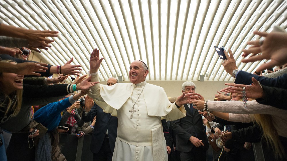 Pope Francis is cheered by faithful upon his arrival for the weekly general audience in the Pope Paul VI hall, at the Vatican, Feb. 4, 2015. (Photo by L'Osservatore Romano/Pool/AP)
