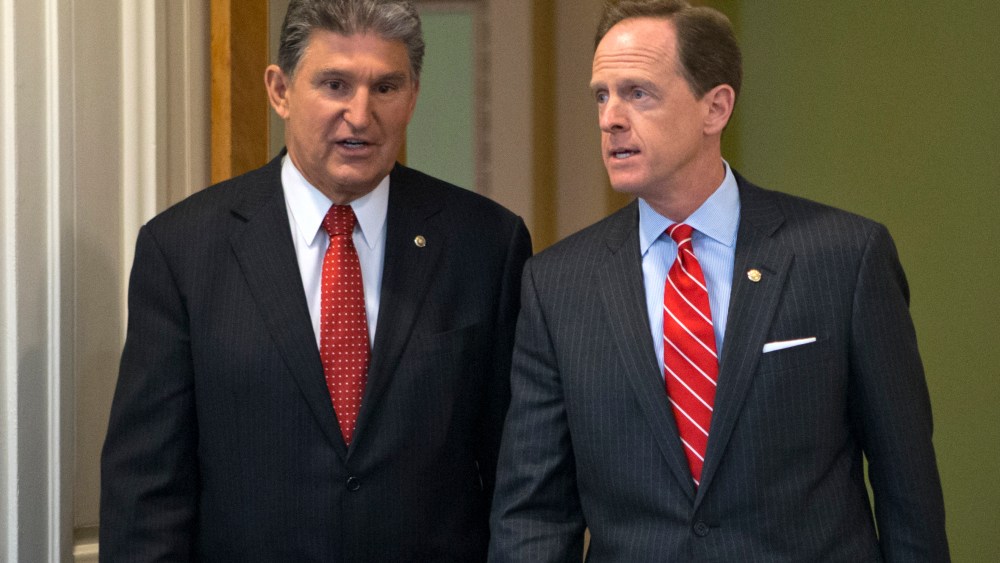 Sen. Joe Manchin of West Virginia, D-W.Va., left, and Sen. Patrick Toomey, R-Pa., arrive at a news conference on Capitol Hill in Washington, Wednesday, April 10, 2013, to announce that they have reached a bipartisan deal on expanding background checks...