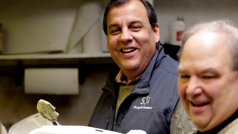 New Jersey Gov. Chris Christie, left, and Newark Archbishop Bernard Hebda converse while preparing plates to hand out during a pre-Thanksgiving meal at the St. John's Church soup kitchen on Nov. 26, 2014, in Newark, N.J.
