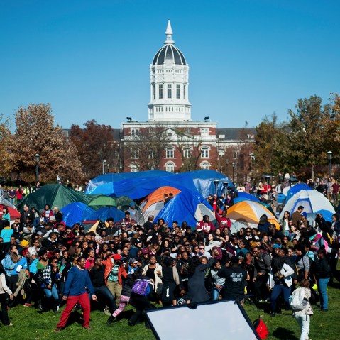 Supporters of Concerned Student 1950 celebrate following University of Missouri System President Tim Wolfe's resignation announcement, Nov. 9, 2015, at the protest movement's camp area in Columbia, Mo. (Photo by Nick Schnelle/Columbia Daily Tribune/AP)