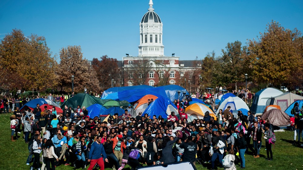 Supporters of Concerned Student 1950 celebrate following University of Missouri System President Tim Wolfe's resignation announcement, Nov. 9, 2015, at the protest movement's camp area in Columbia, Mo. (Photo by Nick Schnelle/Columbia Daily Tribune/AP)