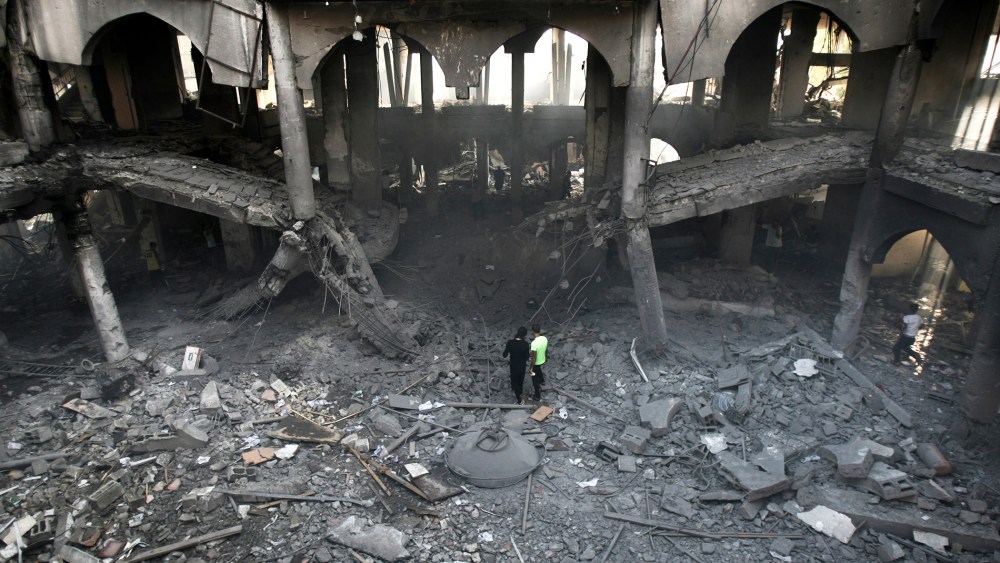 Palestinians inspect the damage of a Rafah commercial center after an Israeli strike in Rafah, in the southern Gaza Strip, Aug. 24, 2014. (Photo by Eyad Baba/AP)