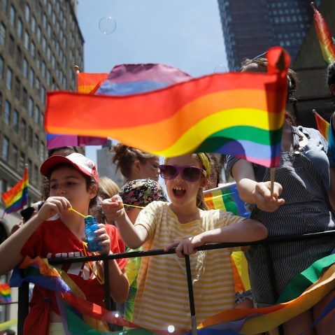 Children blow bubbles as they pass by on a float in the Gay Pride Parade in New York on June 29, 2014. (Photo by Seth Wenig/AP)