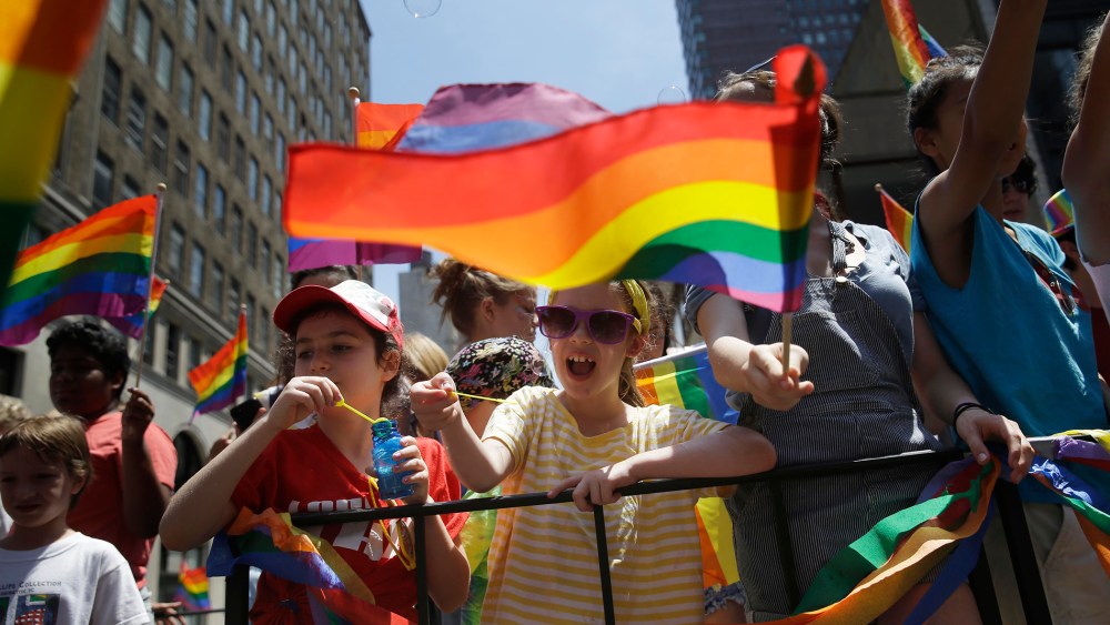 Children blow bubbles as they pass by on a float in the Gay Pride Parade in New York on June 29, 2014. (Photo by Seth Wenig/AP)
