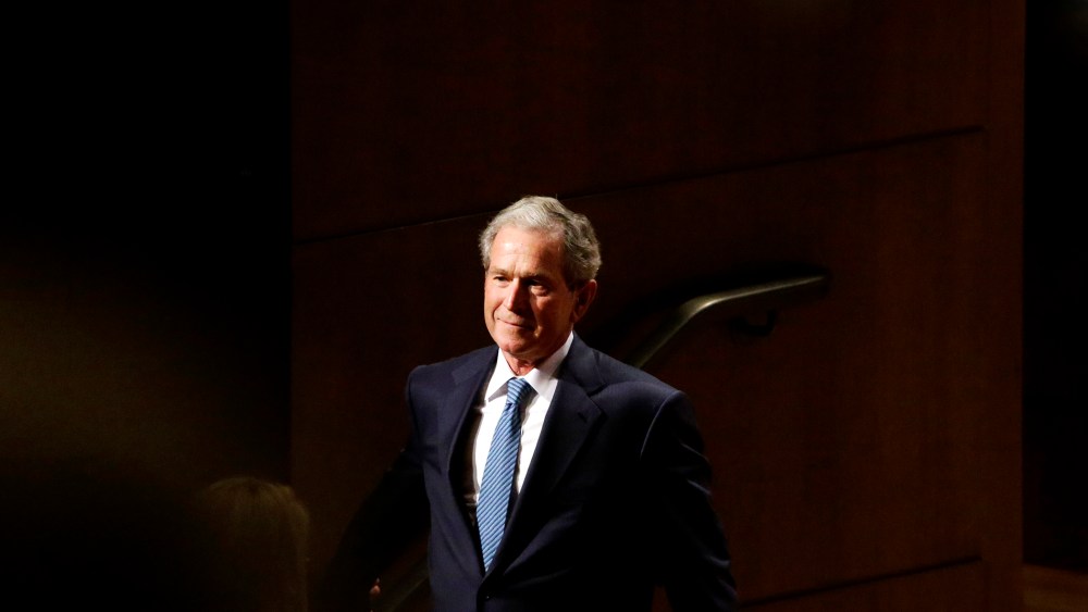 Former President George W. Bush smiles as he walks off stage during an event on Feb. 19, 2014, in Dallas, Texas. (Photo by LM Otero/AP)