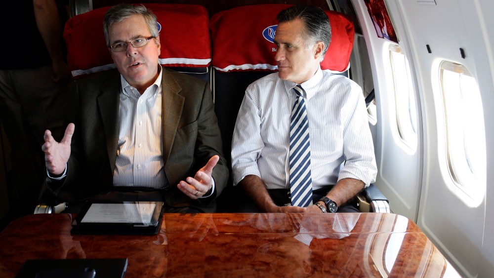 Republican presidential candidate, former Massachusetts Gov. Mitt Romney talks with former Florida Gov. Jeb Bush as they fly on his campaign plane to Miami Fla., Oct. 31, 2012. (Photo by Charles Dharapak/AP)