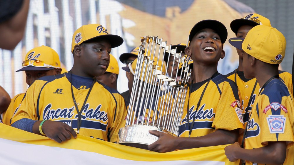In this Aug. 27, 2014, file photo, members of the Jackie Robinson West Little League baseball team participate in a rally in Chicago celebrating the team's U.S. Little League Championship. (Photo by Charles Rex Arbogast/AP)