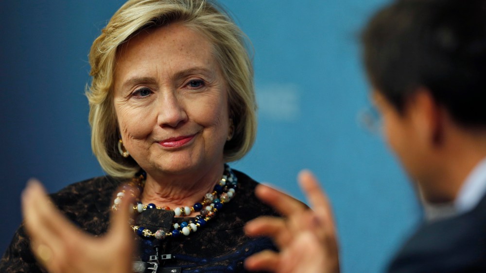 Former U.S. Secretary of State Hillary Clinton, left, listens to Robin Niblett, right, Director of Chatham House, during an event in London, Friday, Oct. 11, 2013.