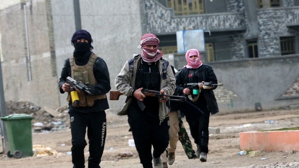 Gunmen patrol during clashes with Iraqi security forces in Fallujah, 40 miles west of Baghdad, Iraq, Jan. 5, 2014.