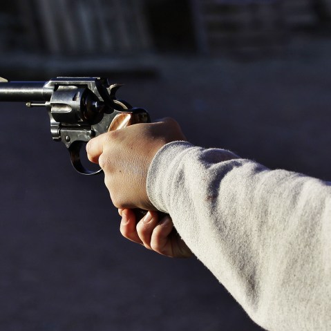 A man shoots a revolver, at Dragonman's firing range and gun dealer, outside Colorado Springs, Colo., Sunday Dec. 23, 2012. (Photo by Brennan Linsley/AP)
