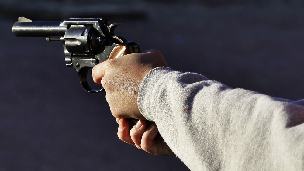 A man shoots a revolver, at Dragonman's firing range and gun dealer, outside Colorado Springs, Colo., Sunday Dec. 23, 2012. (Photo by Brennan Linsley/AP)