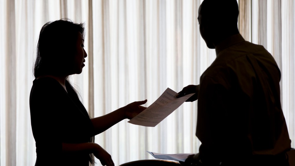 Recruiter Christina O takes an applicants resume during a job fair in Philadelphia, June 23, 2014.