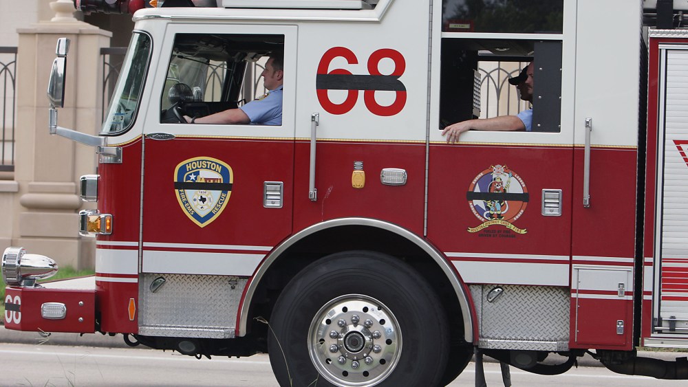 Houston Fire Department ladder truck 68 drives in a procession, June 2, 2013, in Houston. (Photo by James Nielen/Houston Chronicle/AP)