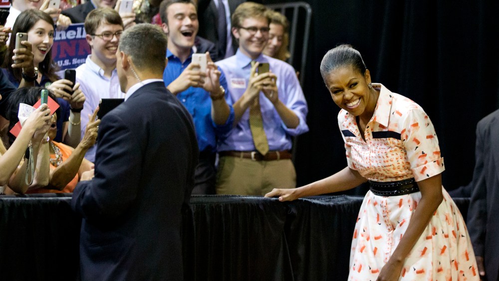 First lady Michelle Obama steps out from backstage as she's introduced by Democratic U.S. Senate candidate Michelle Nunn at a voter registration rally on Sept. 8, 2014, in Atlanta.  (David Goldman/AP)